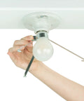 Person installing Clip On Ceiling Light Cover That Hides Exposed Bulbs In Seconds Easy No Fuss Fixture Shield For Most Light Fixtures