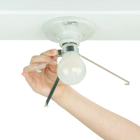 Person installing Clip On Ceiling Light Cover That Hides Exposed Bulbs In Seconds Easy No Fuss Fixture Shield For Most Light Fixtures