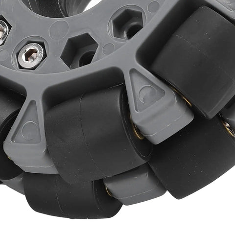 Close-up of 100mm Double Plastic Omnidirectional Wheel For Robotic Platforms Beefed Up Nylon Core With Rubber Rollers And Brass Tube Bearings 20kg Carrying Capacity Replacement Kit For Robot Racing And DIY Builds, showing rubber rollers and brass tube bearings.