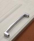 Crystal U Shaped Drawer Pull Handles In Bright Chrome With Screws installed on a cabinet door, minimalist design