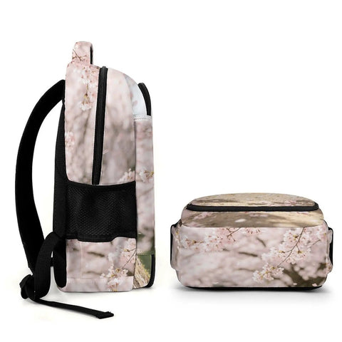 Side and top view of Soft Pink Sakura Spring Scene Printed Unisex Backpack with large capacity and durable polyester design.