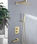 Brushed Gold Wall Mounted Shower System With Large Rainfall Head And Detachable Handheld Super Smooth Pressure Flow Instant Temperature Control Total Bathroom Glow Up Built Like A Tank For Everyday Luxury mounted on gray wall with water spray.