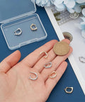 8Pcs 18K Gold Plated Necklace Shortener Clasp Brass Enhancer Set With Cubic Zirconia on hand, showing gold and silver clasps