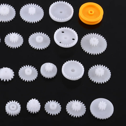 Durable Plastic Gear Kit Set For DIY Robots Cars And Tech Projects Includes 64 Wearable Crown Pulley Belt Gears Built Tough For Long Service Life Perfect For Creative Model Building And Mechanic Hobbyist Gadgets, assorted white plastic gears on black