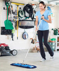 Woman using Badass Heavy Duty 24 Inch Nylon Dust Mop Head For Hardwood Floors in garage for cleaning.