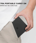 Person slipping Ultra Slim Mini Coffee Scale With Timer For Espresso And Baking into pocket, highlighting portability