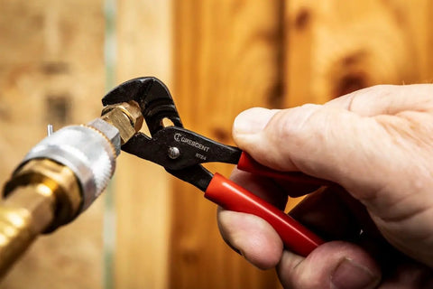 Mini Dipped Handle Tongue And Groove Pliers With Precision Grip For Home And Pro Projects, 4 1/2 Inch Jaw in use on pipe