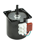 Mini gear motor with mounting bracket, black cylindrical body, metal shaft, white connector block and red capacitor.