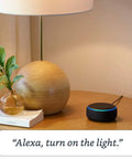 Hella Compact Smart Speaker With Alexa Built In Drops Kickass Soundwaves Smooth For Cozy Rooms Stereo Pairing Ready Charcoal Shell on a nightstand.