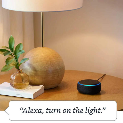 Hella Compact Smart Speaker With Alexa Built In Drops Kickass Soundwaves Smooth For Cozy Rooms Stereo Pairing Ready Charcoal Shell on a nightstand.