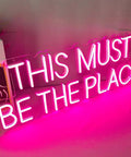 This Must Be The Place Neon Sign Pink Wall Decor For Bedroom And Party Vibes, Large Quote Neon Light 23x9 inches against wall