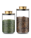 Top Notch Slick Large Glass Kitchen Jars Set Of Four Aluminum Lids countertop organization with green and brown tea leaves.