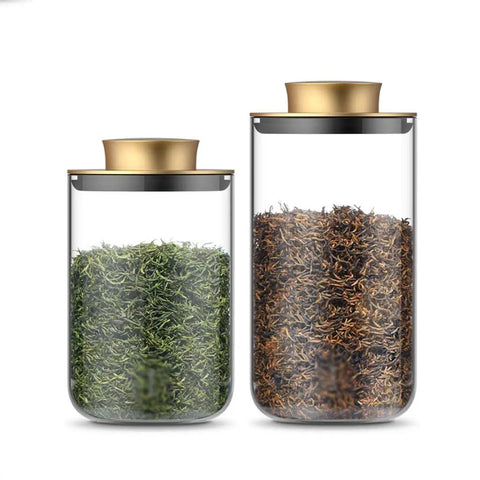 Top Notch Slick Large Glass Kitchen Jars Set Of Four Aluminum Lids countertop organization with green and brown tea leaves.