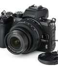 Nikon Z50 camera with Two Pack 46mm Front Lens Cap With Deluxe Cap Keeper, Center Pinch Design, shown with lens attached