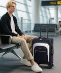 Flight Ready Carry On Luggage 22x14x9 Inches Airline Approved Softside 20 Inch Spinner Wheels With TSA Lock next to traveler at airport