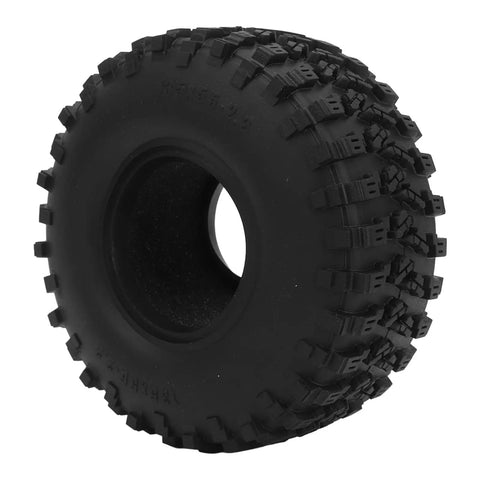 Close-up of a black textured off-road tire with deep treads, side view.