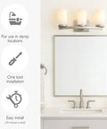 Three Light Slick Satin Nickel Bathroom Light Fixture With Frosted Glass Shades above a mirror in a bathroom