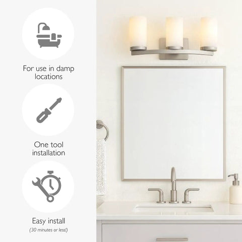 Three Light Slick Satin Nickel Bathroom Light Fixture With Frosted Glass Shades above a mirror in a bathroom