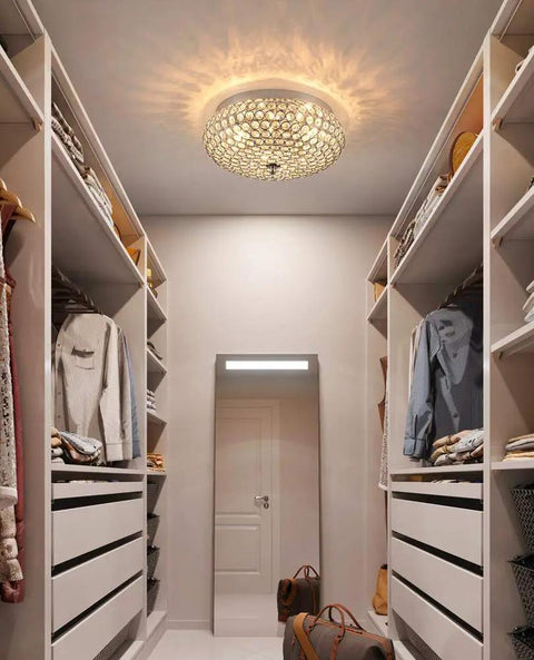 Crystal Flush Mount Ceiling Light Fixture With Sparkling Crystals, Modern Chandelier in sleek closet setting, warm glow reflection.