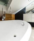 Top Notch Dual Hole Bathtub Drain Overflow Plate With Slick Chrome Finish and Included Matching Screws seen on white bathtub.