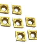 Top Notch Indexable Carbide CCMT060204 Inserts For Internal Turning Jobs On Metal Lathes, seven gold carbide tips arranged.