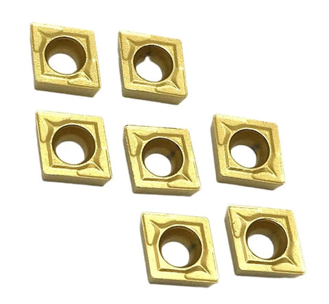 Top Notch Indexable Carbide CCMT060204 Inserts For Internal Turning Jobs On Metal Lathes, seven gold carbide tips arranged.