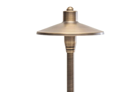Close-up of the head of a G2 12V Brass Path Light from 4 Pack Kit with 3W 2700K Warm White G4 LED Bulbs For Low Voltage Landscape Lighting.