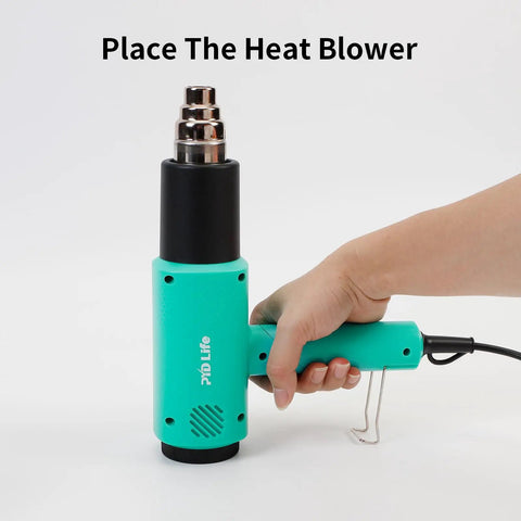 Hand holding Mint Green Heat Blower Gun With Foldable Handle For Sublimation Blanks And Shrink Wrap Film, 110V 1300W Hot Air Gun