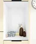 White Contact Paper Peel And Stick Wallpaper for Cabinets and Walls lining a wooden shelf with bottles and towels.