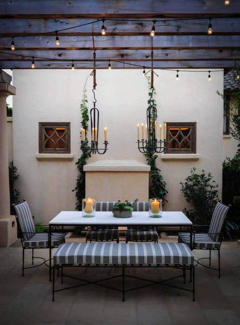 Solar String Lights With 15 LED Bulbs Waterproof Outdoor Lights illuminate pergola over garden dining area, creating cozy glow.