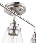Close-up of the Mika 3 Light Track Lighting Kit In Matte Black With Clear Glass Shades Bulbs Not Included Mid Century Modern Vibe.
