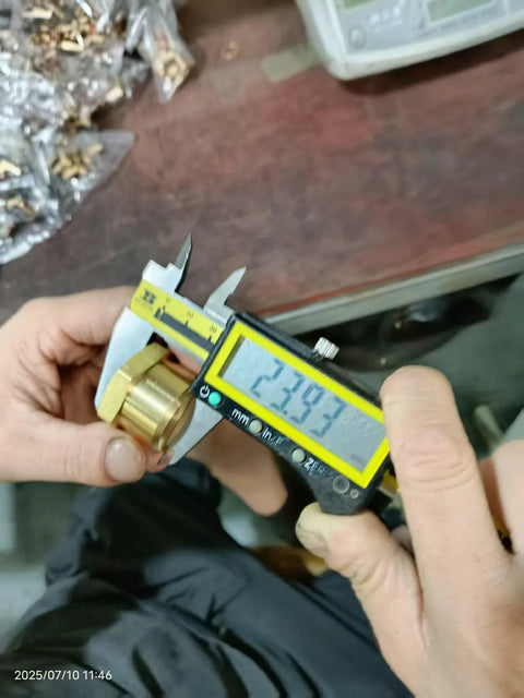 Brass 3/4 in NPT female pipe cap with hex head being measured with a digital caliper