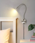 Dimmable LED Wall Reading Light With USB Charging Port For Late Night Reading And Work Gooseneck Bedside Lamp With Flexible Arm 3W Nickel Finish 120V Plug In Warm White Glow mounted beside bed and plant on nightstand