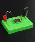 Electric Motor Model And Electromagnetic Swing Kit For Classroom Learning on green base with coiled wire and terminals