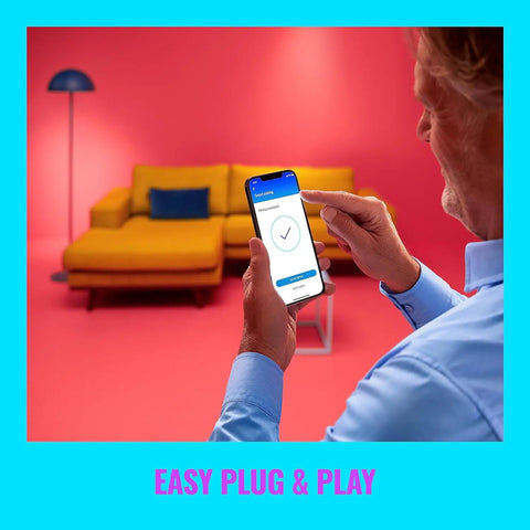 Man using app for Portable Multicolor LED Light Bar With Dope Smart Dimming, 16 Million Colors in a colorful living room scene.