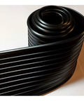 Close-up of coiled black durable foam core garage door bottom weather seal for 16 feet wide doors fits 8000 9000 foam core overhead doors.