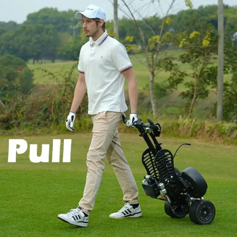Man pulling Electric Four Wheel Foldable Golf Cart Trolley With Easy Push Or Ride Options In Classic Black Trim across the green.