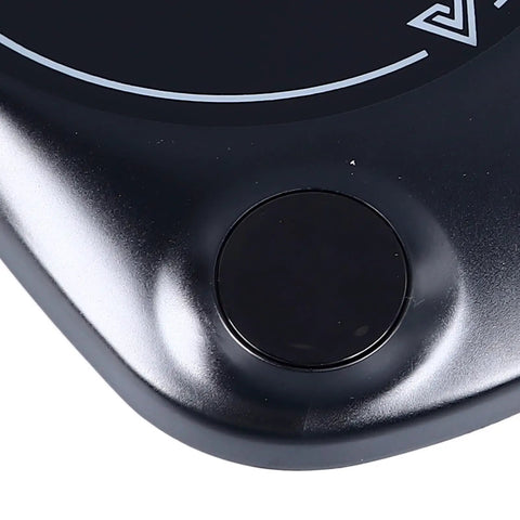 Fast Heating Electric Mug Warmer Featuring Four Adjustable Heat Settings And Smart Auto Shutoff control button close-up on sleek surface.