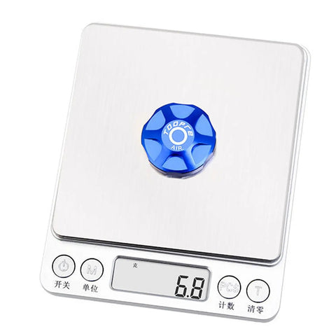 Front Fork Cap Suspension Cover for Mountain Bikes Aluminum Alloy Air Chamber Guard on digital scale, showing weight of 6.8 grams