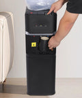 Person using Triple Temperature Water Dispenser With Hot Cold Warm Water Output For Coffee Tea And More Five Gallon Floor Standing Electric Cooler And Heater With Child Lock For Home Office Cafes Black