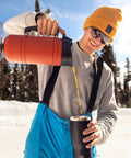 Insulated French Press Keeps Your Daily Joe Hella Hot For Hours With Tough Stainless Steel Build And Secure Twist Lid Crafted For Cabin Weeks And Backyard Chillin 32 Fl Oz Red Rock pouring into a cup in snowy outdoors.