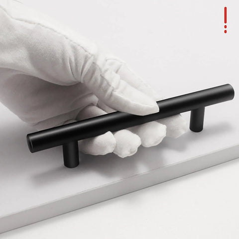 Gloved hand holding matte black handle from 15 Pack Black Cabinet Handles 5 Inch Stainless Steel Drawer Pulls With Precise Hole Spacing