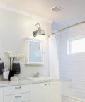 Bathroom interior with two Gooseneck Barn Light Mason Farmhouse Outdoor Wall Sconces in galvanized gray above mirrors.