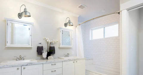 Bathroom interior with two Gooseneck Barn Light Mason Farmhouse Outdoor Wall Sconces in galvanized gray above mirrors.