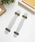Overhead view of 2 Slick Vintage Zinc Alloy Cabinet Pulls with White PU Leather Grip on white surface