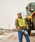 Heavy Duty 1 1/2 Inch Air Impact Wrench With D Handle held by worker near a Komatsu loader during snow.