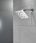 Raincan Shower Head With H2Okinetic Technology Single Setting Metal Shower Head Delivers a Power Drench Spray on bathroom wall
