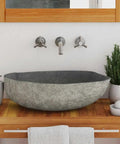 HKPWRBFG River Stone Sink Oval Wash Basin Bathroom Countertop Vessel on wooden vanity with accessories.