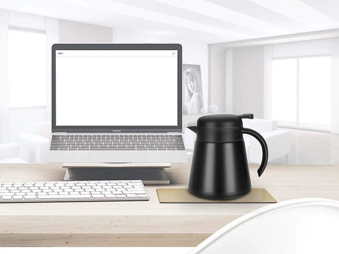 Monster 68 Ounce Stainless Steel Vacuum Insulated Coffee Carafe with Double Wall Construction on office desk near laptop