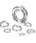 M12 split lock washers, stainless steel, shiny silver finish, scattered on white background